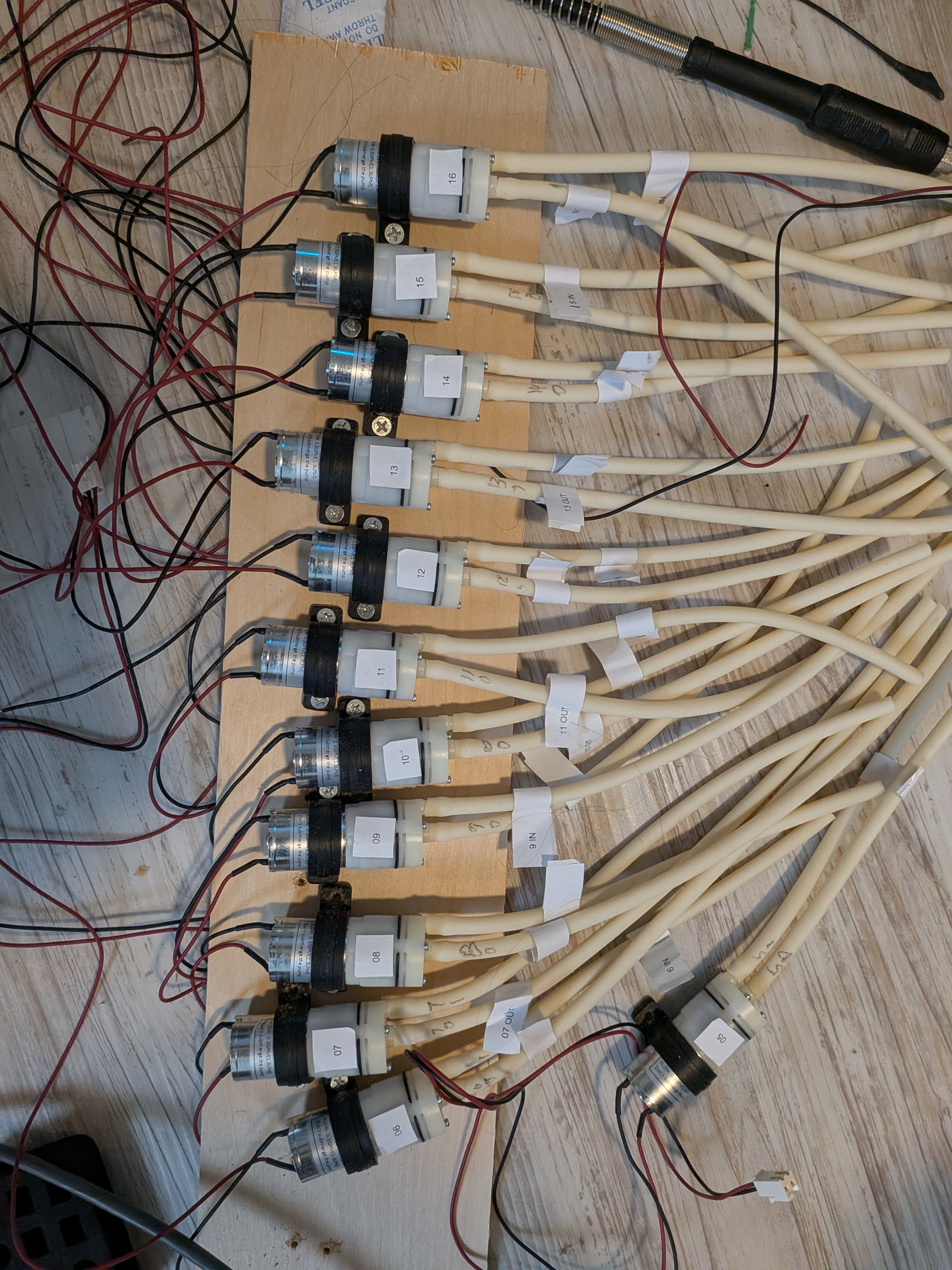 16 peristaltic pumps wired and labeled on a test board